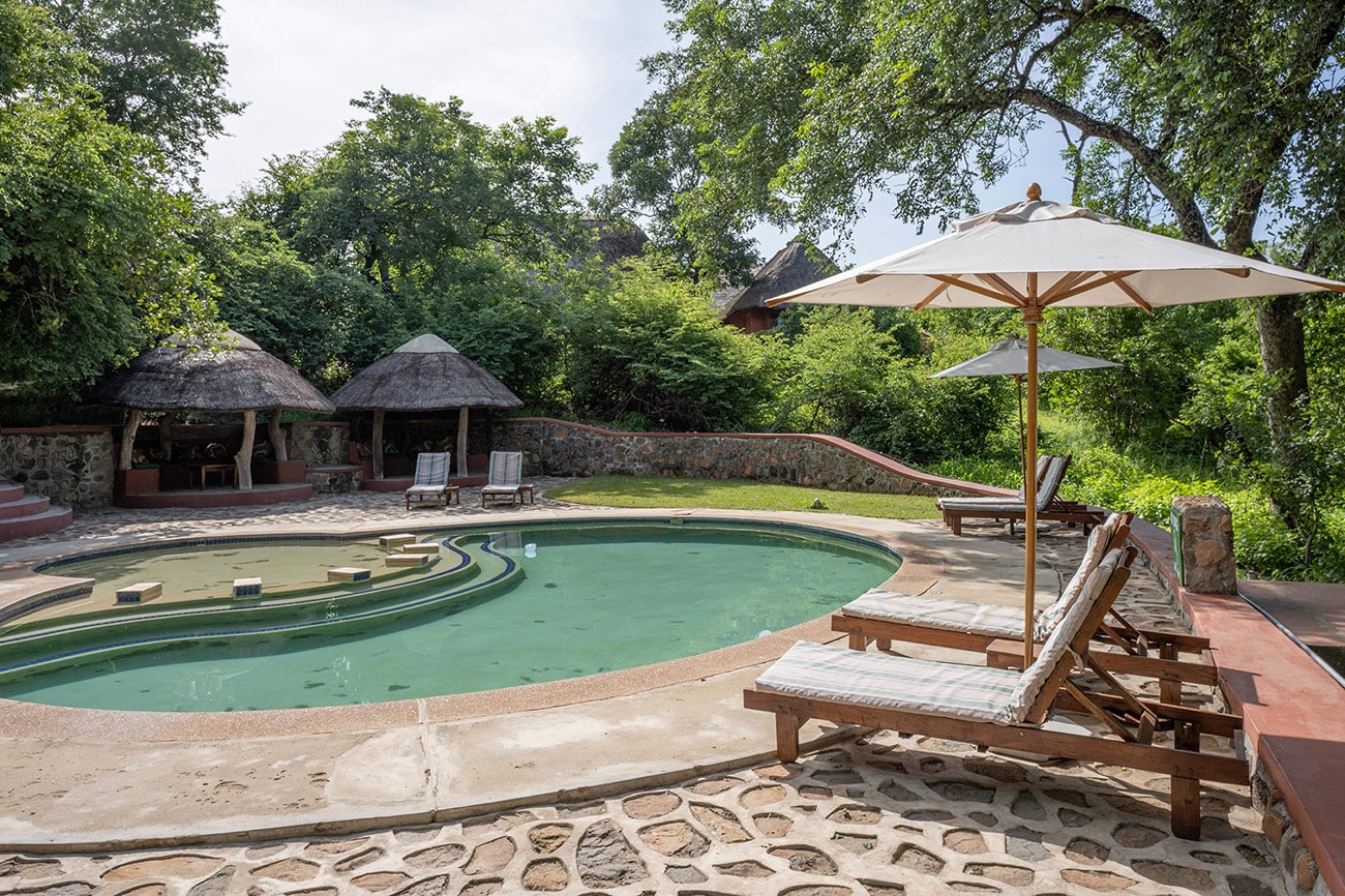 Relax by the pool for a swim and a meal  at Majete Wildlife Reserve
